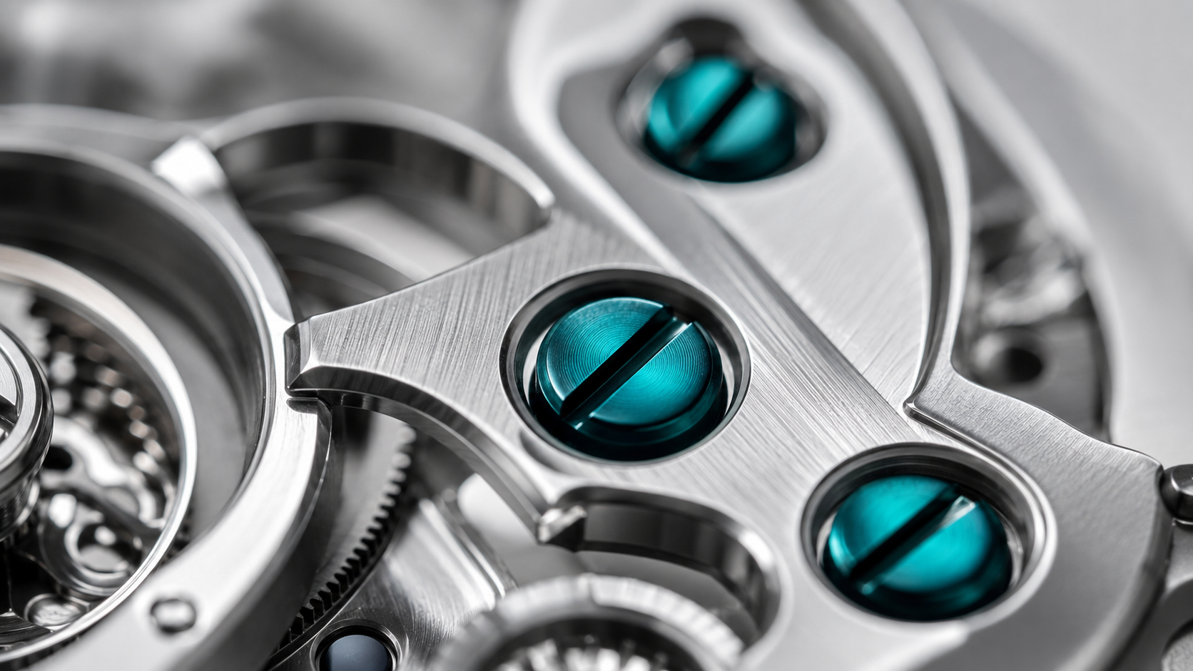 Macro des vis teal sur platine acier brossé.